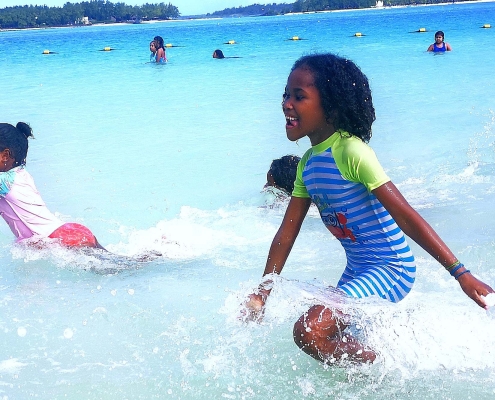 Children splashing at the beach