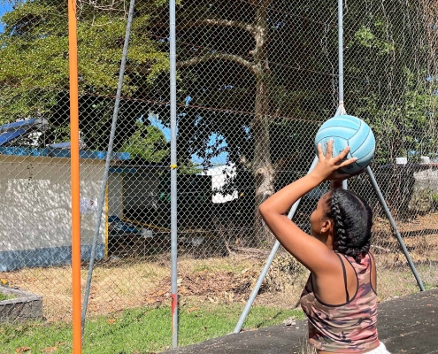 A girl taking a netball shot